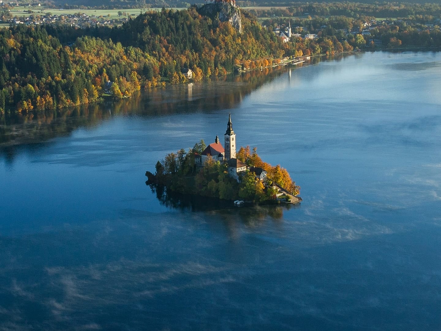 Detail of the photo: the island church of Lake Bled, Slovenia, with Bled Castle on the cliff behind
